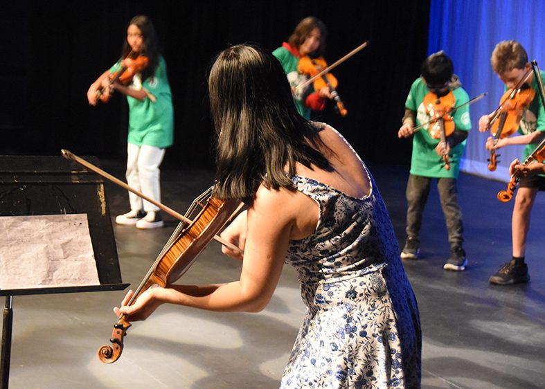 Group of students playing violin at the Showcase concert