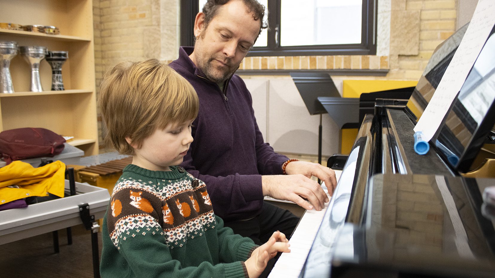 Student learning to play piano at the Manitoba Conservatory of Music & Arts