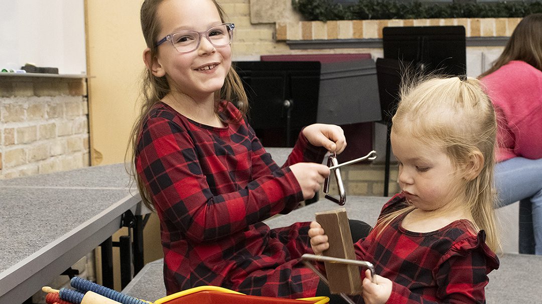 Children playing instruments at Sing-a-Long with Santa event