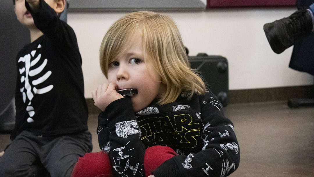 Intro to Instruments student playing harmonica