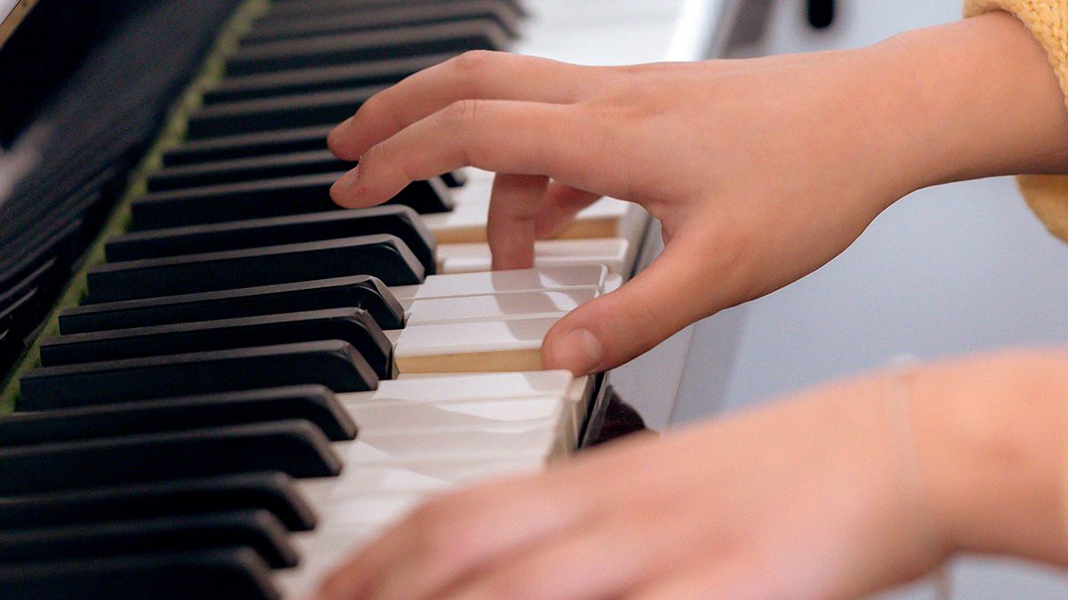 Student playing piano