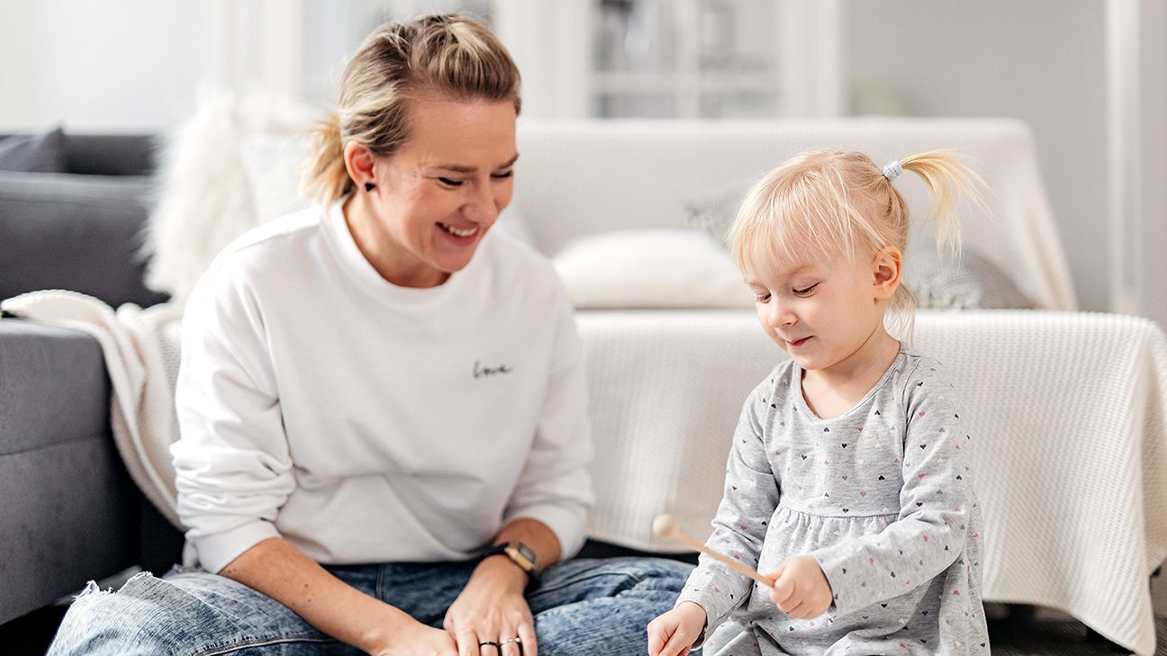 Caregiver and child making music together