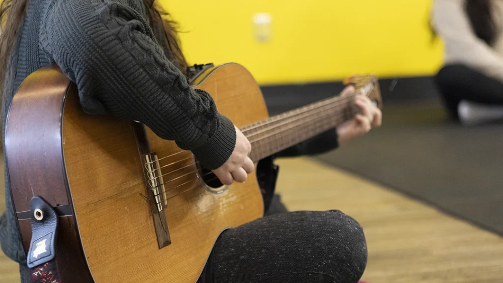 Baby Beats instructor, McKenna Ogg, playing her guitar