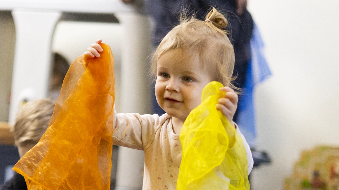 Baby Beats participant holding scarves