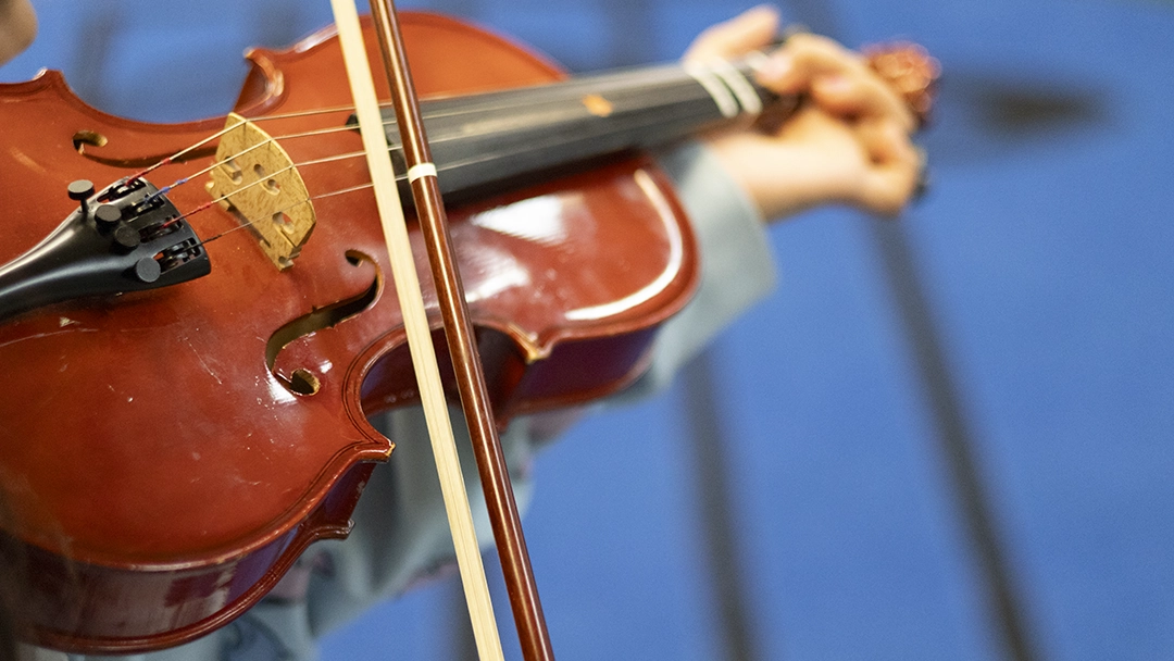 Child holding a violin
